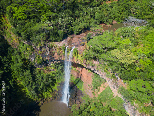Aerial view on Chamarel waterfall, Mauritius island. Beautiful view of green tropical forest with high waterfall.