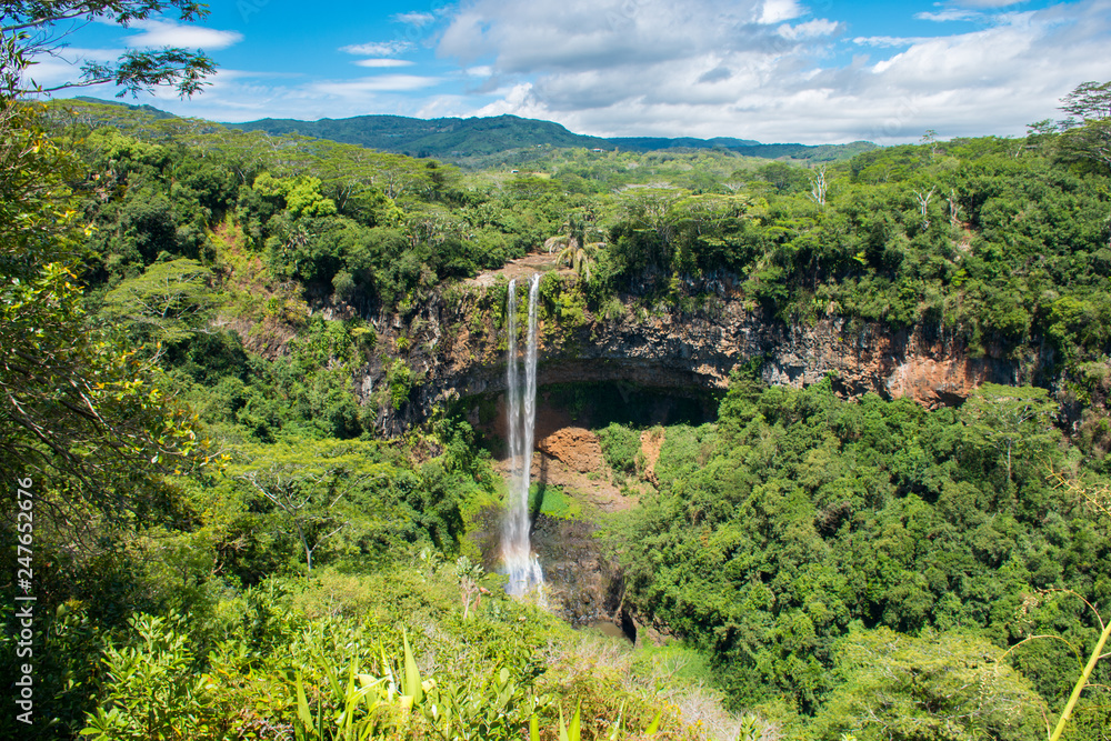 Chamarel waterfall, Mauritius island. Beautiful view on green tropical forest with high waterfall.
