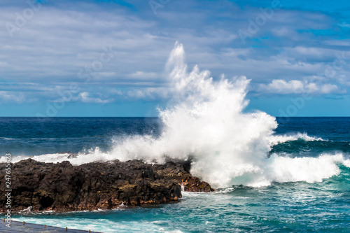 Mesa Del Mar, Tenerife, Spain - A violent wave hits the rocky coast in the north of Tenerife on a day in October.