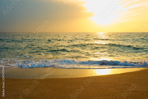 Fototapeta Naklejka Na Ścianę i Meble -   Tropical sandy beach. Sunset seascape. Waves with foam hitting sand.