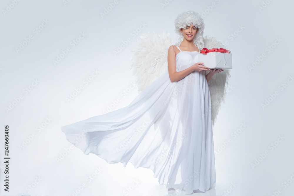 Girl with angel wings and a white dress. Angel girl. Cupid woman. Girl with angel wings and a white dress. Angel girl. Cupid woman.