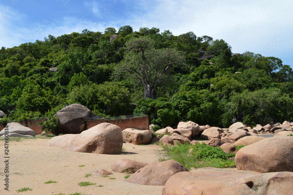 The third largest and second deepest lake in Africa - lake Malawi, surrounded by green trees and stones The third largest and second deepest lake in Africa - lake Malawi, surrounded by green trees and stones