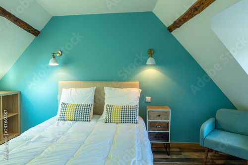 Large modern turquoise atic bedroom in Bed and breakfast guest room photo