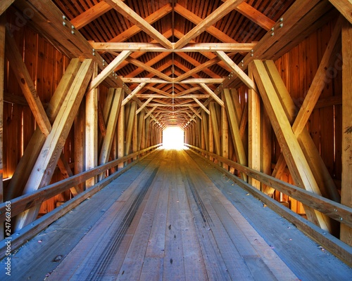 Inside Lowe's Covered Bridge in Maine, with light at the end. 