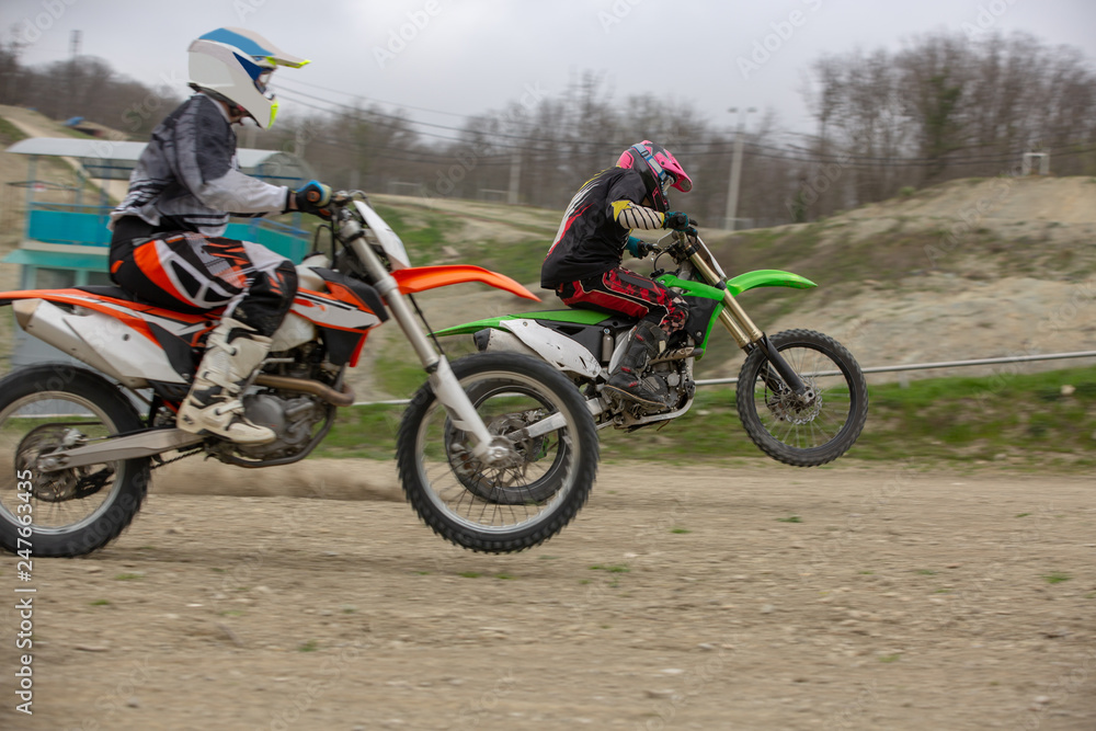 Professional Motocross Motorcycle Rider Drives Over the Road Track.