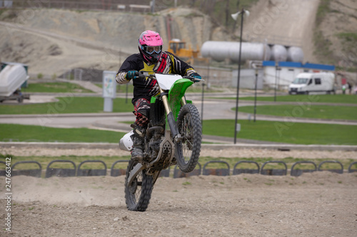 Professional Motocross Motorcycle Rider Drives Over the Road Track.