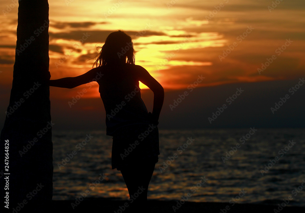 silhouette of young woman at sunset