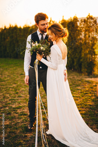 Wedding photos of charming lovers. Sunny summer day. Dry lavender flowers