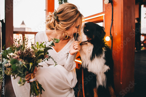Bride on her wedding day and her favorite dog, Sennenhund Bernese