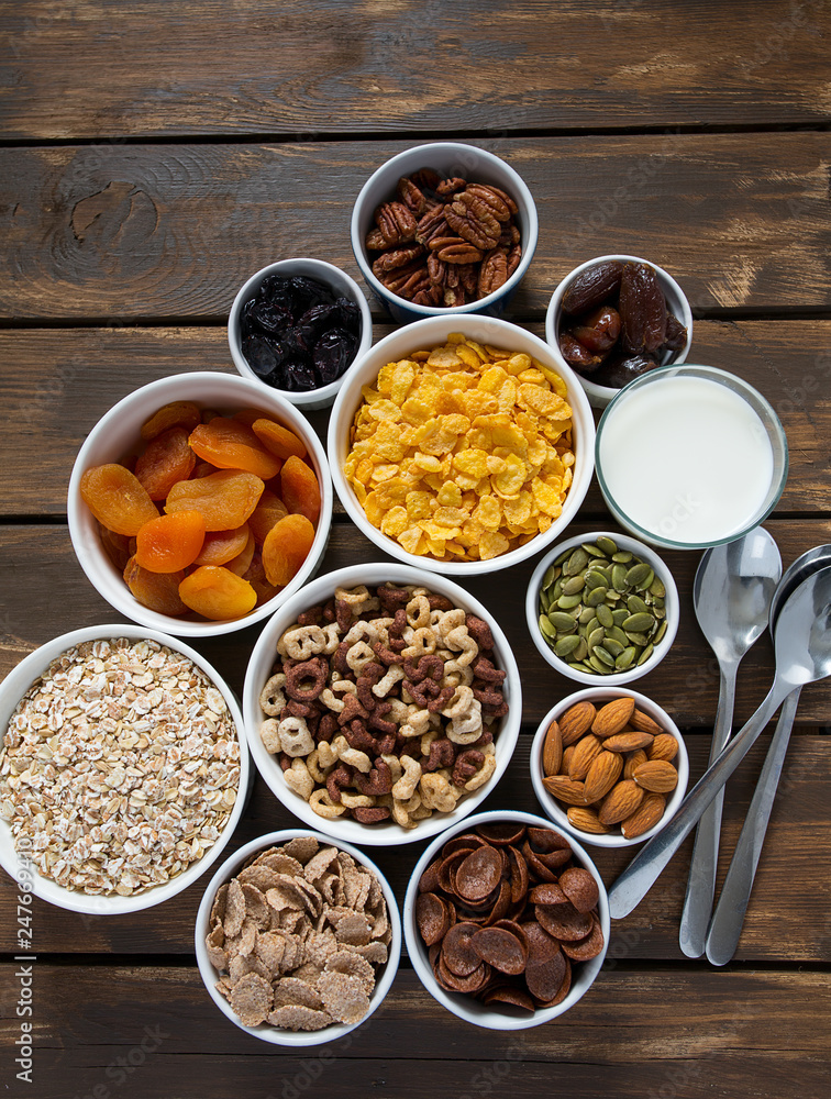 various cereals, nuts and dried fruits on wooden surface various cereals, nuts and dried fruits on wooden surface