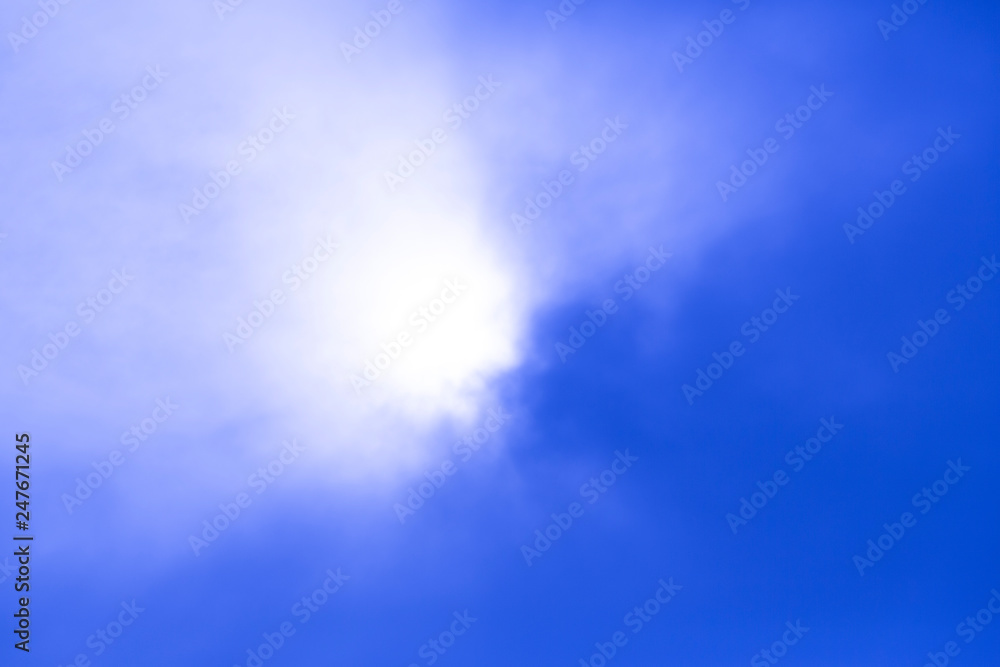 deep blue sky view with sun behind the cloud