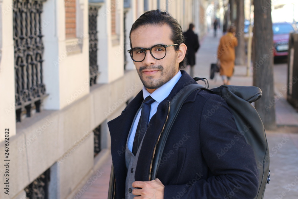 Ethnic fashionable businessman walking outdoors Ethnic fashionable businessman walking outdoors
