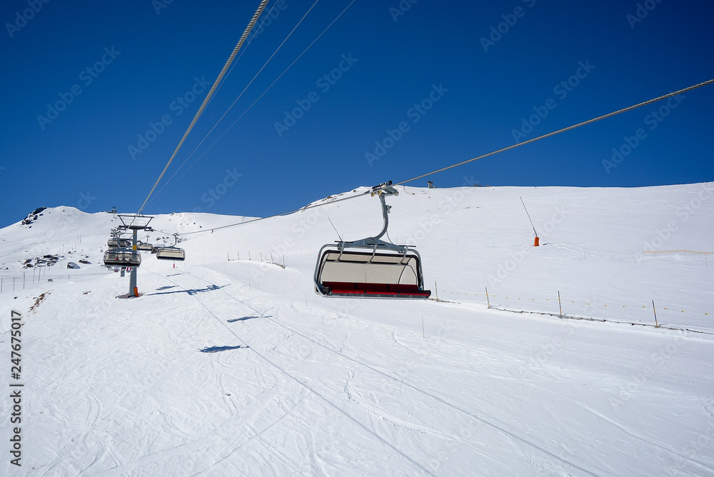 Chair Lift in the Alps with sunshine
