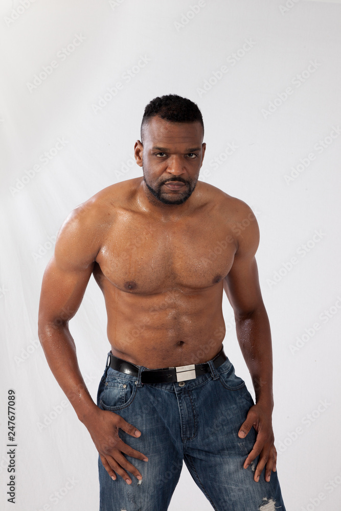 Serious Black man with his shirt off Serious Black man with his shirt off