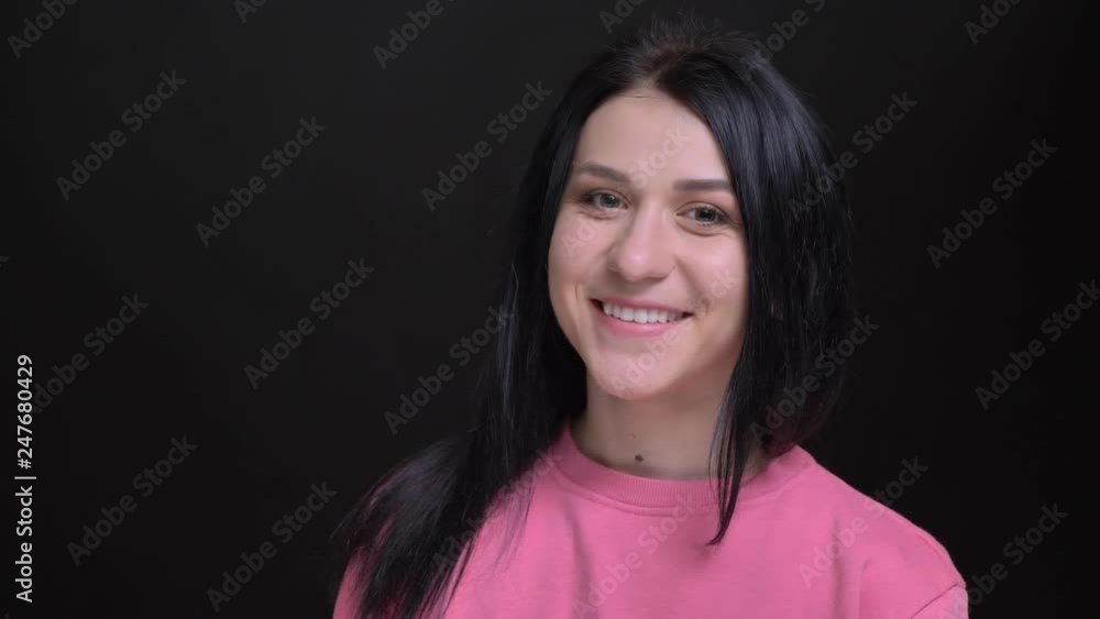 Closeup portrait of young beautiful caucasian girl turning and looking at camera smiling happily Closeup portrait of young beautiful caucasian girl turning and looking at camera smiling happily