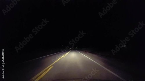 Driving Rural Countryside Road Into the City at Night.  Driver Point of View POV Entering Urban Lights From Country Street