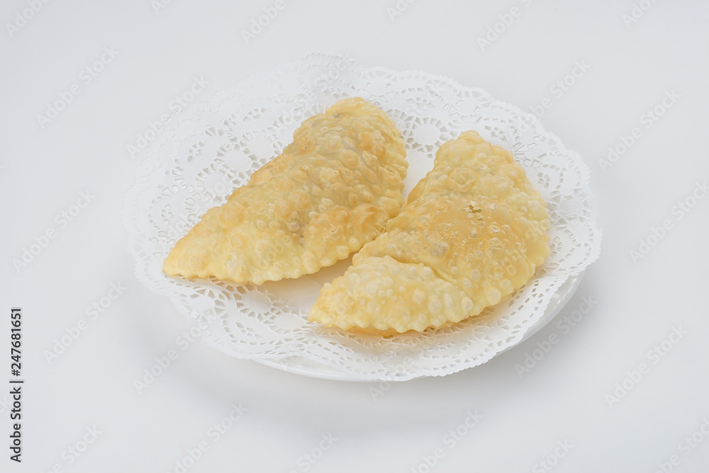 Chebureki on the plate isolated on white Chebureki on the plate isolated on white