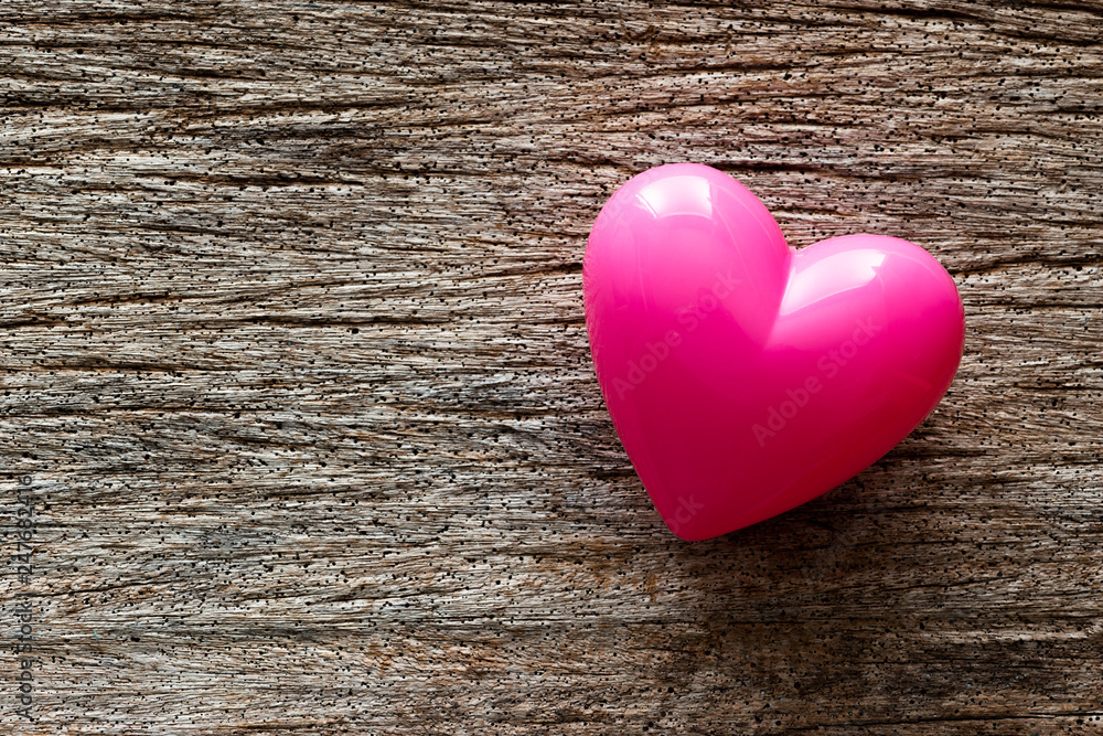 Pink heart on rustic wood