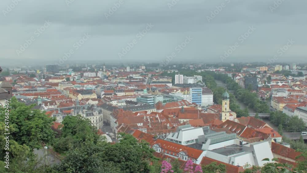 panoramic moving view on austrian Graz city from famous Schlossberg castle hill in rainy weather panoramic moving view on austrian Graz city from famous Schlossberg castle hill in rainy weather