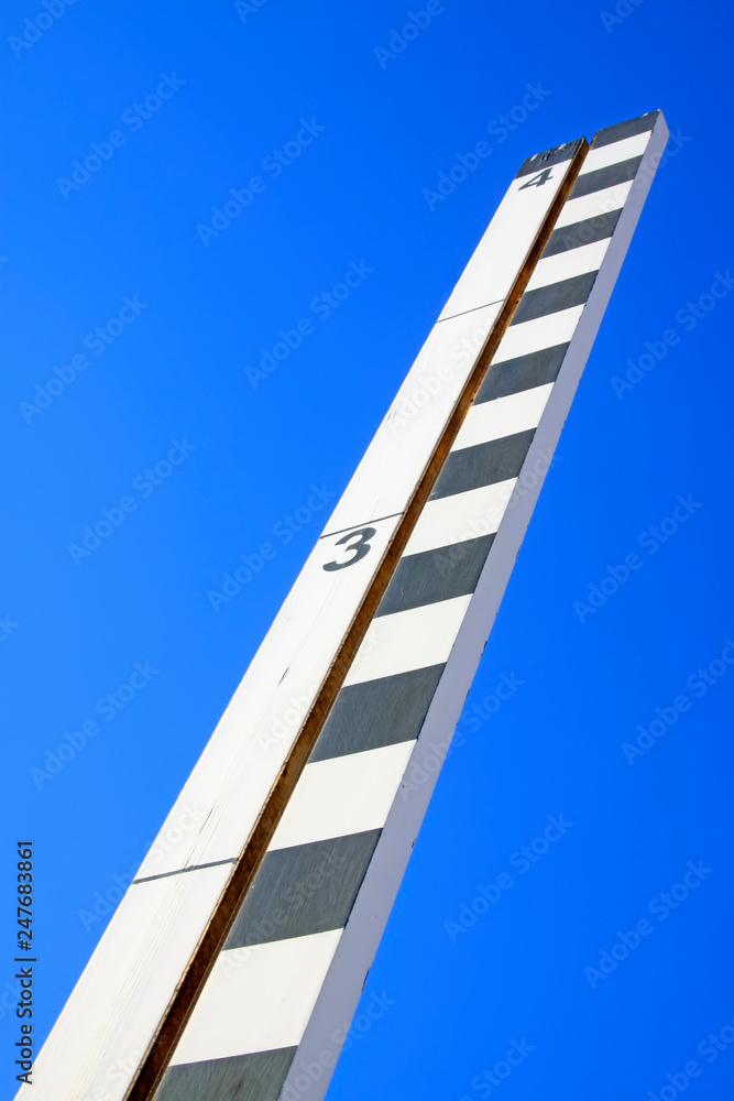 Wooden ruler under the sky background Wooden ruler under the sky background