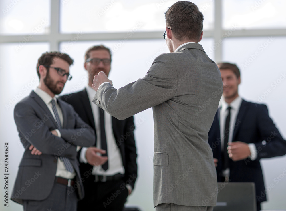 business background.a group of business colleagues standing in the office business background.a group of business colleagues standing in the office