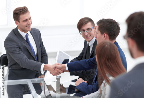 handshake business partners at a meeting