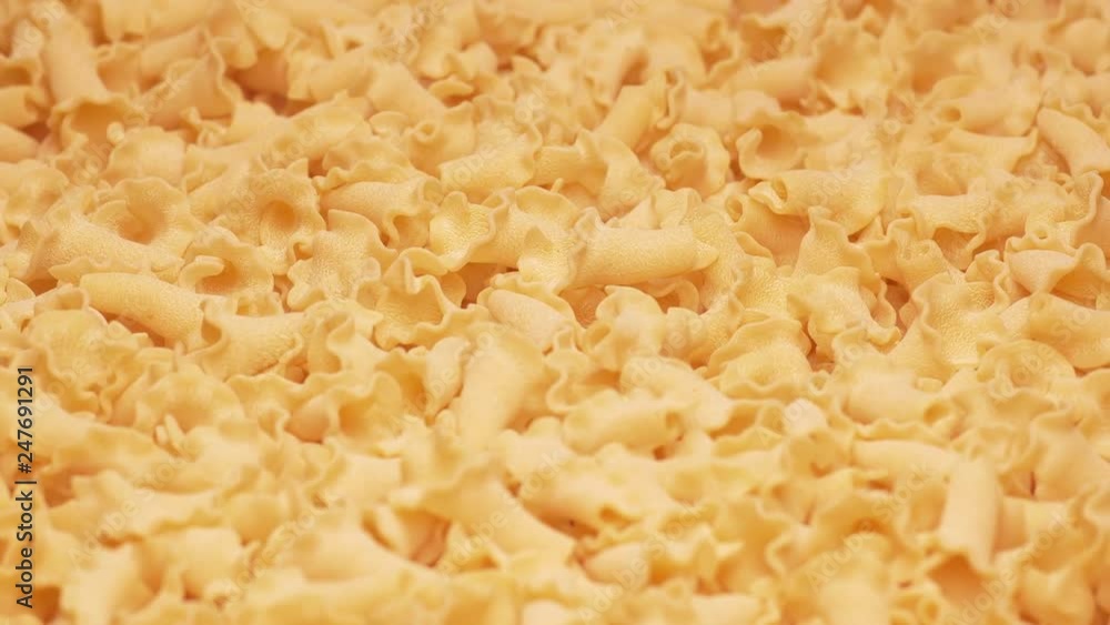 UHD closeup shot of the dry Campanelle pasta on a rotating stand UHD closeup shot of the dry Campanelle pasta on a rotating stand