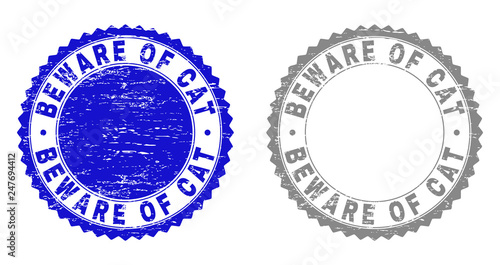 Grunge BEWARE OF CAT stamp seals isolated on a white background. Rosette seals with grunge texture in blue and grey colors. Vector rubber watermark of BEWARE OF CAT tag inside round rosette.