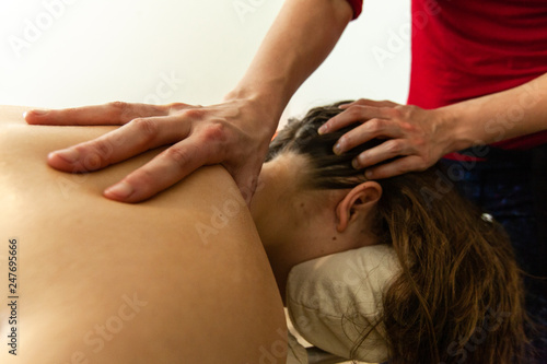 Woman's hands giving a massage. Close up of woman's hands massaging the neck of a woman, in a professional environment