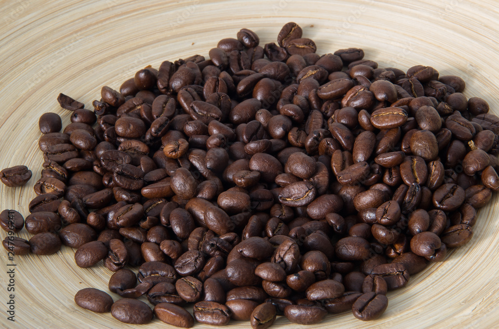 Fototapeta premium Coffee beans in bamboo Cup close-up