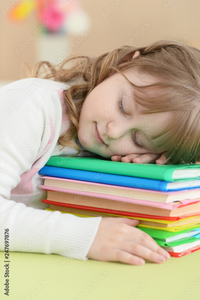 Portrait of cute schoolgirl sleeping on table Portrait of cute schoolgirl sleeping on table