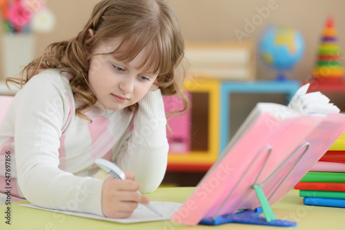 Portrait of girl doing homework at home