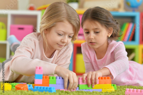 Portrait of girls playing with colorful blocks