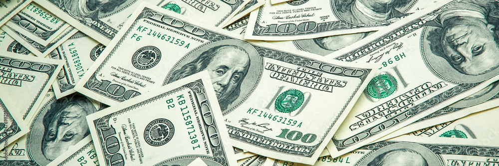 A pile of one hundred US banknotes. Cash of hundred dollar bills, dollar background image. A pile of one hundred US banknotes. Cash of hundred dollar bills, dollar background image.