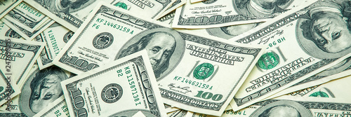 A pile of one hundred US banknotes. Cash of hundred dollar bills, dollar background image.
