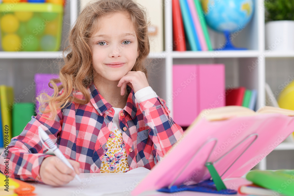 Portrait of little girl doing homework at home Portrait of little girl doing homework at home