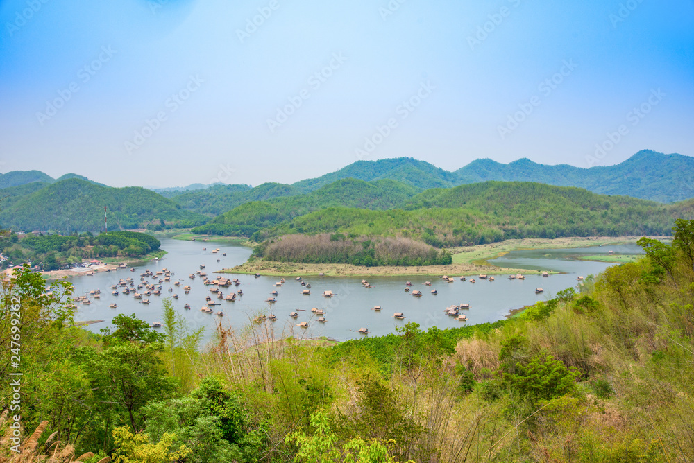 Mountain lake landscape of river green mountain with bamboo houseboat raft floating looking from viewpoint