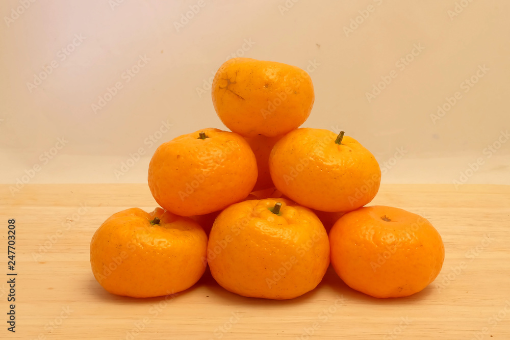 Orange on wood background and space for write wording, very popular tropical fruit making many kinds of food and beverage, vitamin C rich, good for health, anti-aging, important export agriculture pro