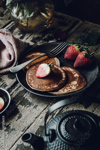 Vegan Banana Pancakes with Strawberries on a Dark Wooden Background