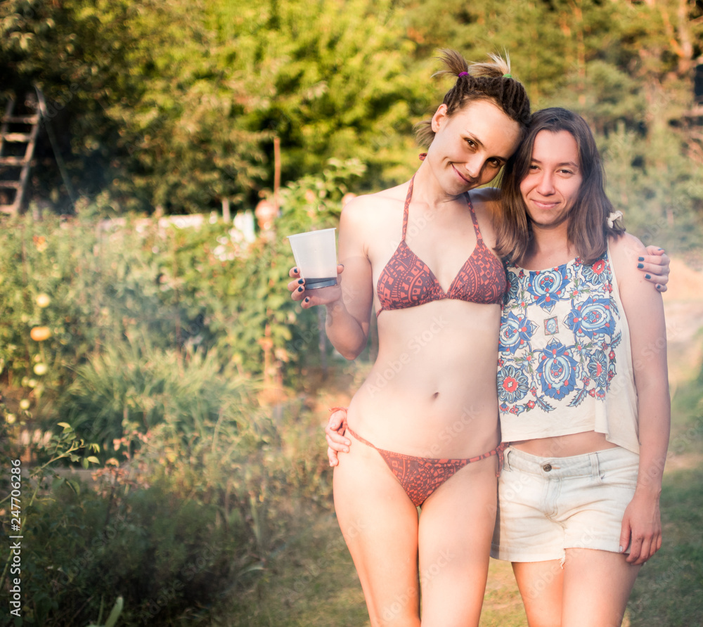 Photo of two friends at a summer picnic in a country house Photo of two friends at a summer picnic in a country house