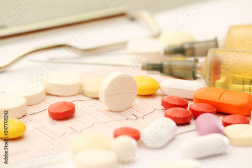 Medication pills and a sirynge as a medical healthcare concept	 photo