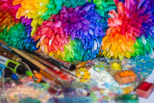 multi-colored chrysanthemums on the palette with paints and brushes of the artist © Мария Балахонцева