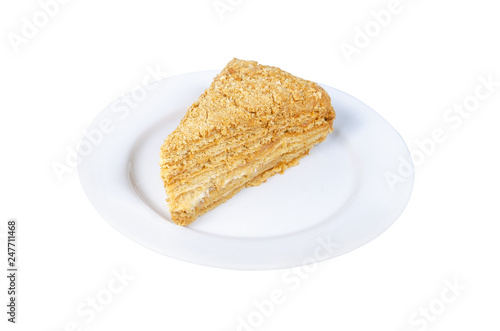 piece of honey cake on a white plate isolated on white background