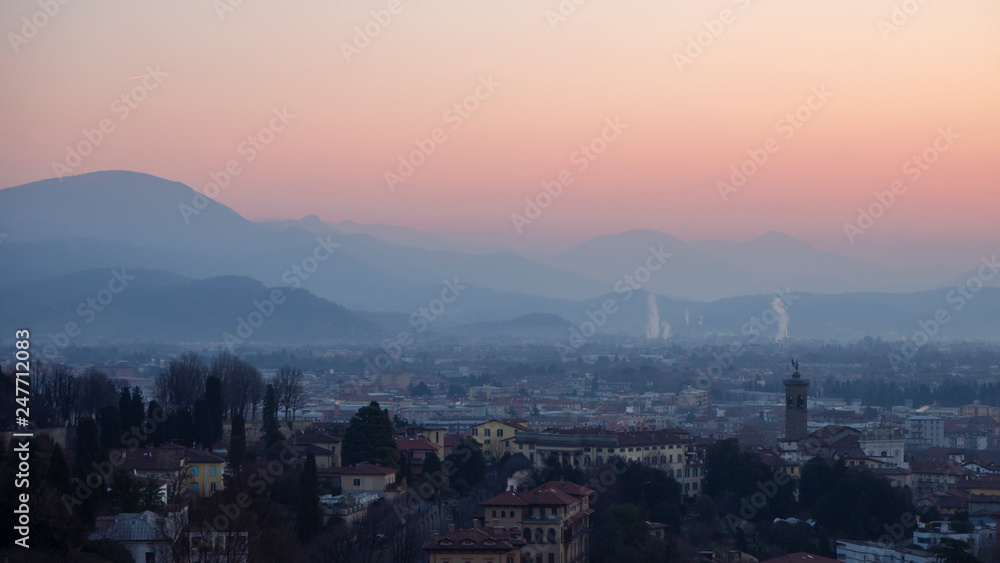 Obraz premium Bergamo, Italy. Landscape to the new city (downtown) at the sunrise from the old town located on the top of the hill