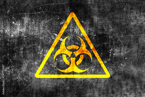 Biohazard sign on old grungy wall. Grunge biohazard symbol. Monochrome black and yellow illustration photo