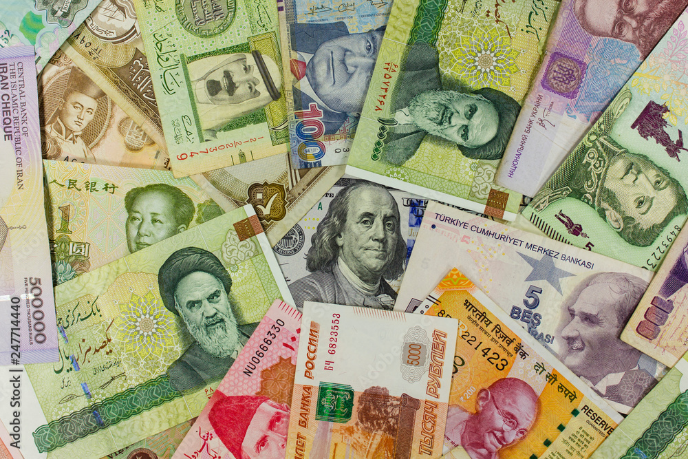 Banknotes of different countries spread around the banknote 100 US