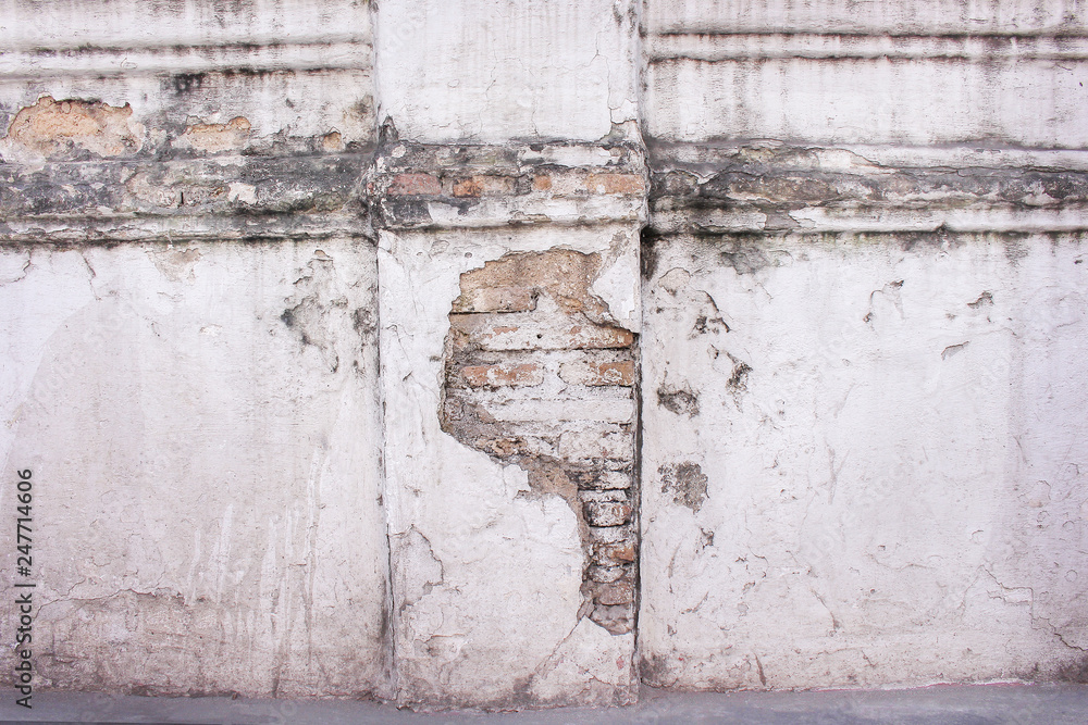Texture old brick decayed and stain patterns abstract on white paint concrete weathered wall in thai temple for background Texture old brick decayed and stain patterns abstract on white paint concrete weathered wall in thai temple for background