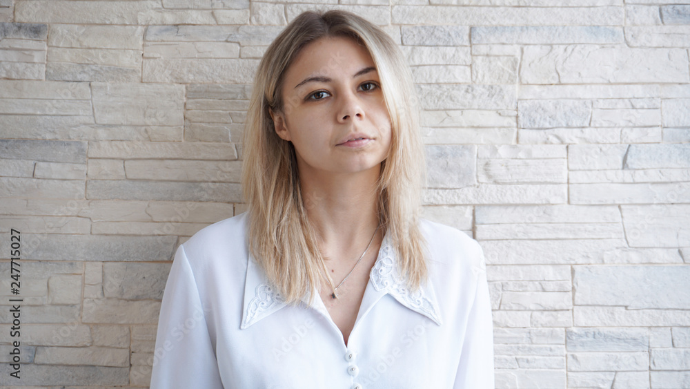 Portrait of attractive young european businesswoman on brick wall background Portrait of attractive young european businesswoman on brick wall background