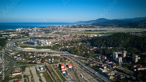 Adler, Sochi, Russia - December 10, 2018: The airdrome of Sochi International Airport with planes on the background of mountains in sunny day