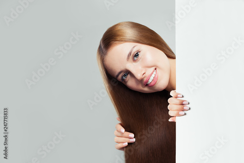 Happy woman with white empty paper board background with copy space for advertising marketing or product placement
